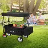 A family having a picnic in a park with a HAUKI wagon in the foreground. Produktbild-Vorschau