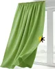 A green curtain is shown hanging in front of a window. Produktbild-Vorschau