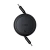 A black, circular Baseus charger with a retractable cable, shown from a top-down perspective against a white background. Náhled obrázku produktu