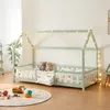 A child's bed with a house-like frame decorated with fairy lights, set in a room with toys on the floor. Anteprima dell’immagine prodotto