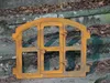 A rusty metal window frame with a door and latch, resting on stone steps with fallen leaves. Produktbild-Vorschau