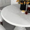 A close-up of a white round table with a clear protective film on top. Náhled obrázku produktu