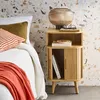 A bedroom scene with a nightstand next to a bed. Produktbild-Vorschau
