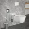 A modern bathroom with a wall-mounted toilet, toilet paper holder, toilet brush, and trash can. Produktbild-Vorschau