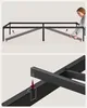 A two-part image showing the assembly of a black metal bed frame. Produktbild-Vorschau