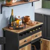A bar cart with bottles of alcohol, glasses, and serving bowls. Produktbild-Vorschau