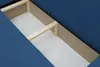Close-up view of the interior storage compartment of a blue sofa. Produktbild-Vorschau