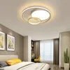 A modern bedroom with a ceiling light, bed, and desk. Podgląd zdjęcia produktu