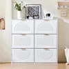 A white shoe cabinet with six drawers, decorated with plants and a radio on top. Produktbild-Vorschau