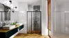 A modern bathroom with a shower enclosure, double vanity, and wooden flooring. Anteprima dell’immagine prodotto
