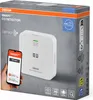 The image shows the packaging of an Osram Smart+ CO Detector, with a smartphone displaying the app interface next to it. Produktbild-Vorschau