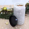 A clear plastic food storage container filled with cereal, placed on a table with Christmas decorations. Anteprima dell’immagine prodotto