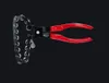 A tool with a chain and handles against a black background. Anteprima dell’immagine prodotto