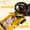 A split image showing the top part of a yellow toy construction vehicle with a steering wheel and the bottom part showing the storage compartment with a stuffed bunny inside. Náhled obrázku produktu