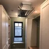 A room with a ceiling-mounted clothes dryer, cabinets, and a window. Náhľad obrázku produktu