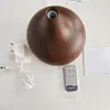 Aroma diffuser, power adapter, remote control, and instructions laid out on a white surface. Produktbild-Vorschau