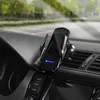 A black wireless car phone charger mounted on a car's air vent, with a phone inside, showing the car's dashboard and the road ahead through the windshield. Produktbild-Vorschau