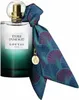 A bottle of perfume with a decorative scarf tied around its neck. Voir les images du produit