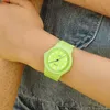 A person wearing a lime green Casio watch on their wrist, with denim fabric in the background. Produktbild-Vorschau