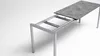 A table with a grey stone-like top, shown in an extended state, on a white background. Produktbild-Vorschau