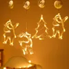 Christmas-themed LED light decorations hanging against an orange wall. Podgląd zdjęcia produktu