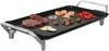 A close-up, studio shot of an electric griddle with food items on it. Voir les images du produit