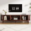 A modern living room with a TV stand and a large TV mounted on the wall. Produktbild-Vorschau