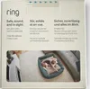 The image shows the packaging of a Ring indoor camera, featuring multilingual text and a lifestyle image of a dog in a bed. Anteprima dell’immagine prodotto