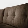 A close-up view of the tufted fabric of a brown sofa. Náhled obrázku produktu