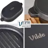 A collage of four close-up images showcasing a black cast iron pot and its details, with the brand logo present in two of the images. Produktbild-Vorschau