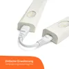 Two white LED under-cabinet lights are connected by a white cable. The lights have a circular sensor and a small LED light. Produktbild-Vorschau