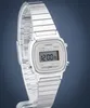 A close-up studio shot of a silver Casio digital watch with a metal band, displayed against a dark blue background. Produktbild-Vorschau