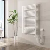A white electric towel radiator mounted on a tiled wall in a modern bathroom. Produktbild-Vorschau