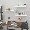 A desk with a laptop, books, and a mug, next to a bookshelf with decorative items. Produktbild-Vorschau