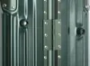 Close-up view of a green suitcase hinge and latches. Náhľad obrázku produktu