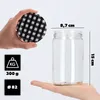A hand holding a lid and another hand holding a glass jar, with dimensions and weight information displayed. Podgląd zdjęcia produktu