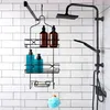 A black metal shower caddy with bottles of shampoo and soap hanging on a tiled wall. Anteprima dell’immagine prodotto