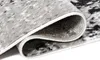 A close-up view of a rolled-up rug, showing the texture and pattern of the fabric. Produktbild-Vorschau
