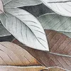 A close-up view of a rug with a leaf pattern. Voir les images du produit