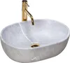 A beige oval Aufsatzwaschbecken (countertop basin) with a gold faucet, isolated on a white background. Náhled obrázku produktu