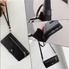 A collage of images showing a black iPhone wallet case with a wrist strap and a crossbody strap, with close-ups of its features. Produktbild-Vorschau