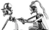 A close-up of two metal figures, one appearing to be a tattoo artist tattooing another person. Podgląd zdjęcia produktu