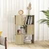 A wooden bookshelf filled with books and decorative items, placed in a room with sheer curtains and a plant. Podgląd zdjęcia produktu
