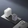 Two charging adapters and a smartphone are placed on a metallic surface with a dark gray background. Voir les images du produit