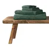 A stack of dark green towels on a wooden bench. Produktbild-Vorschau