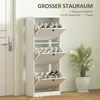 A white shoe cabinet with three flip-down drawers filled with shoes, placed next to a white door and a potted plant. Produktbild-Vorschau