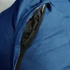 Close-up of a blue beanbag chair with an open zipper pocket. Voir les images du produit