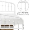 A close-up view of a white metal bed frame, highlighting its design details and showing a portion of the mattress and bedding. Produktbild-Vorschau
