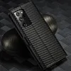 A close-up shot of a carbon fiber phone case with a camera module visible. Produktbild-Vorschau