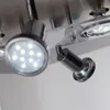 A close-up, low-angle shot of a modern ceiling light fixture with multiple LED spotlights. Náhled obrázku produktu